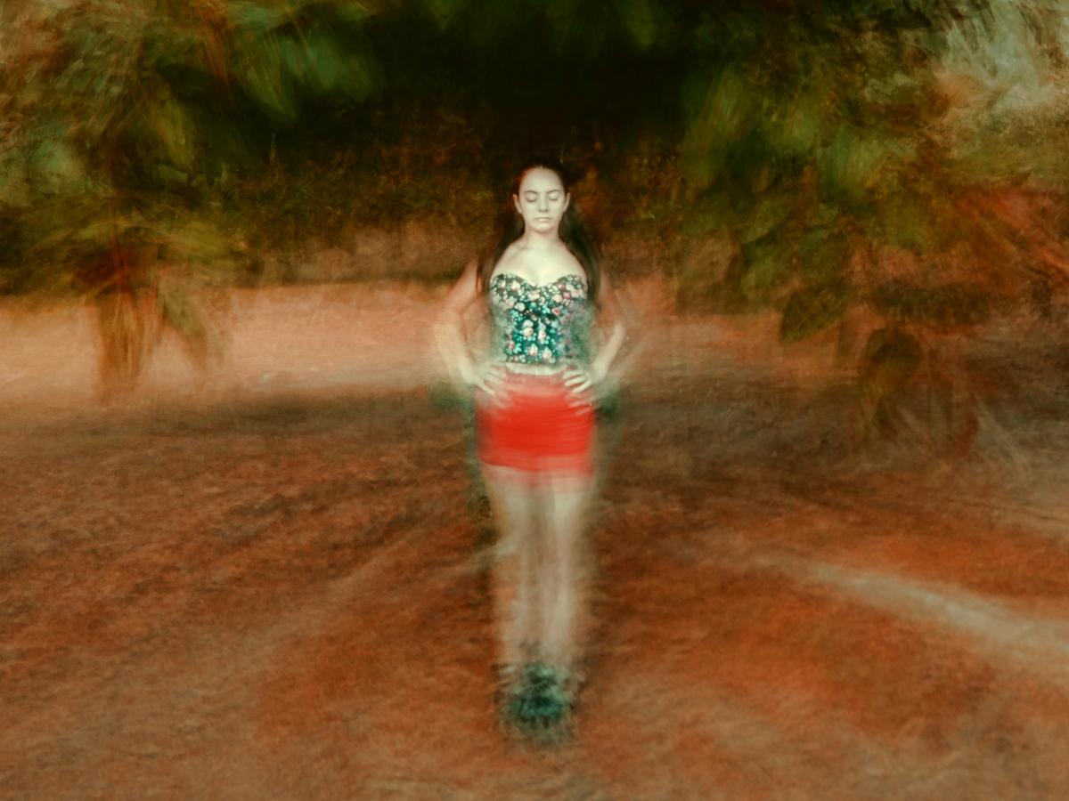 A montage image places a woman, with eyes shut and hands on hip, at the centre of blurred circle of ground and tree branches.