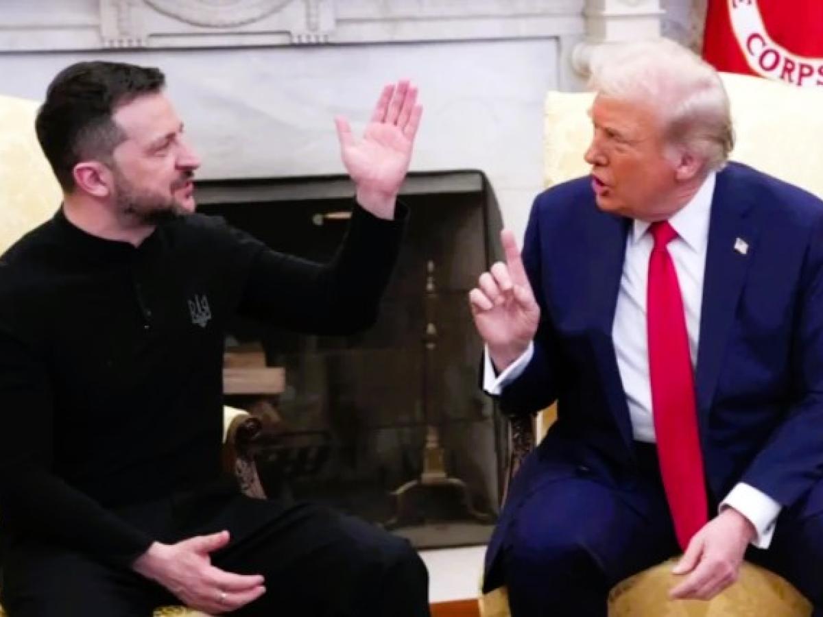 President Zelensky raises a hand while President Trump talks at him.