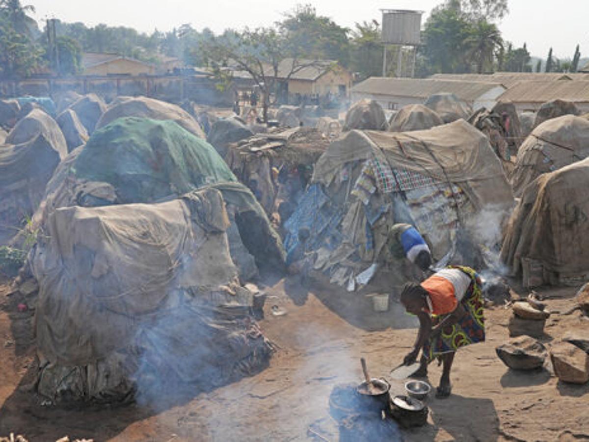 Small huts in a crowded refugee camp.
