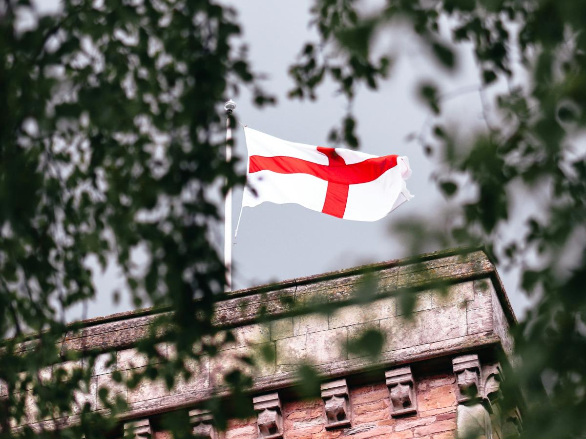 An English flag flies on a church tower.