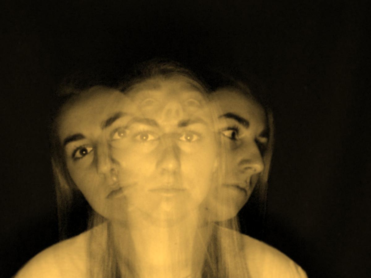 A multiple exposure image shows a womans head and shoulders looking ahead, to the sides and above.