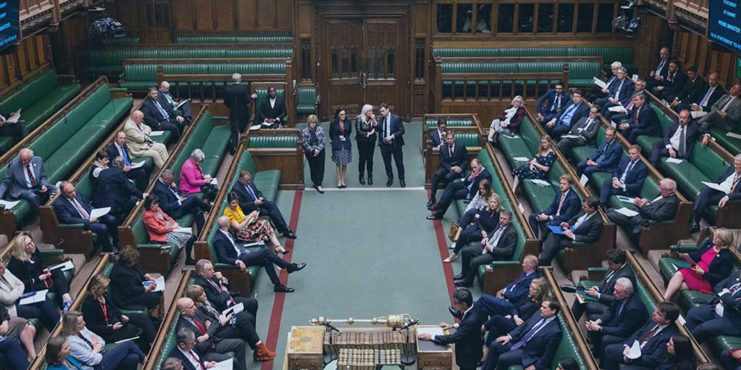 an aerial view down in to the parliamentary chamber shows MPs sitting on benches on the left and right hand side