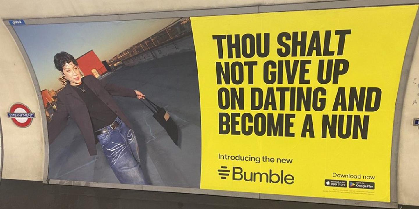 An advert on a Underground platform shows a person next to the slogna: Thou shalt not give up on dating and become a nun.