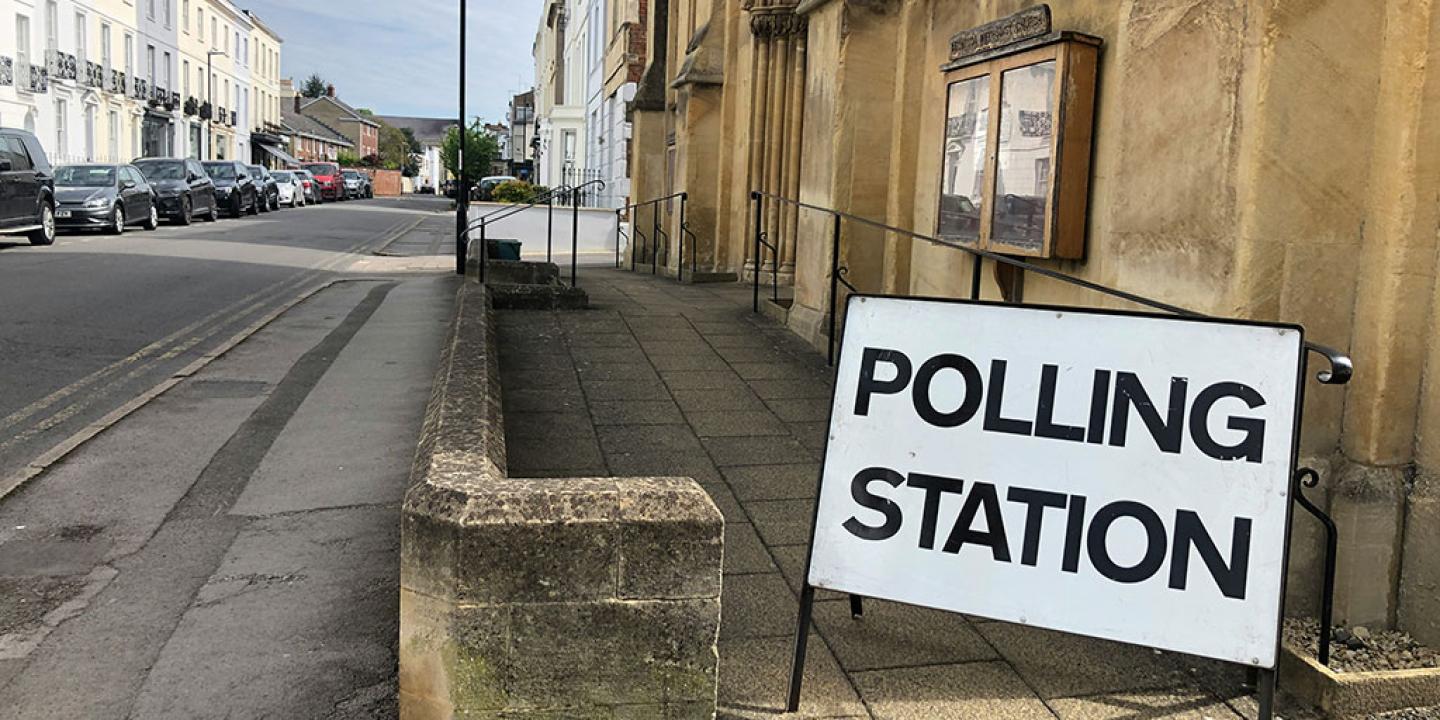 A sign reading 'polling station' stands by the entrance to a church.