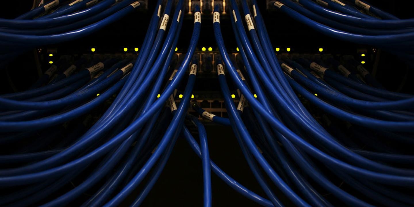 blue cables converge on a server.