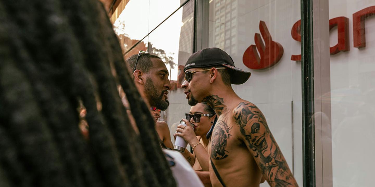 On a street, two men confront each other face to face.