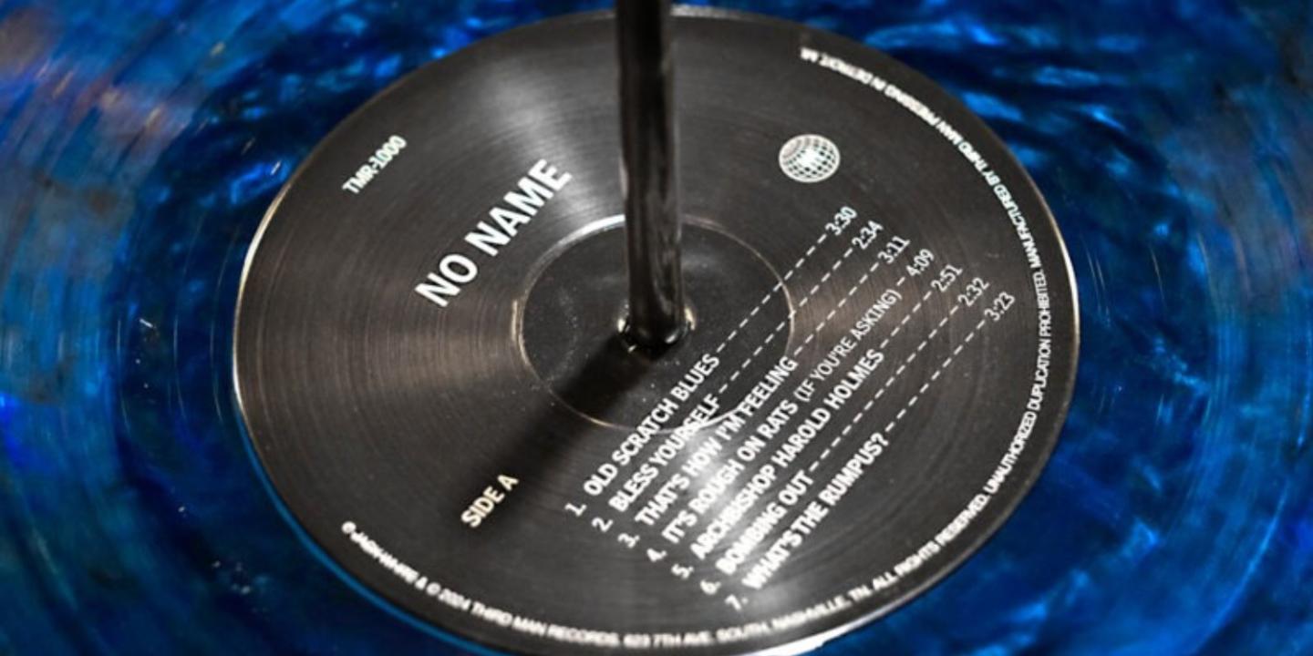 A close-up of the black label of a blue vinyl record