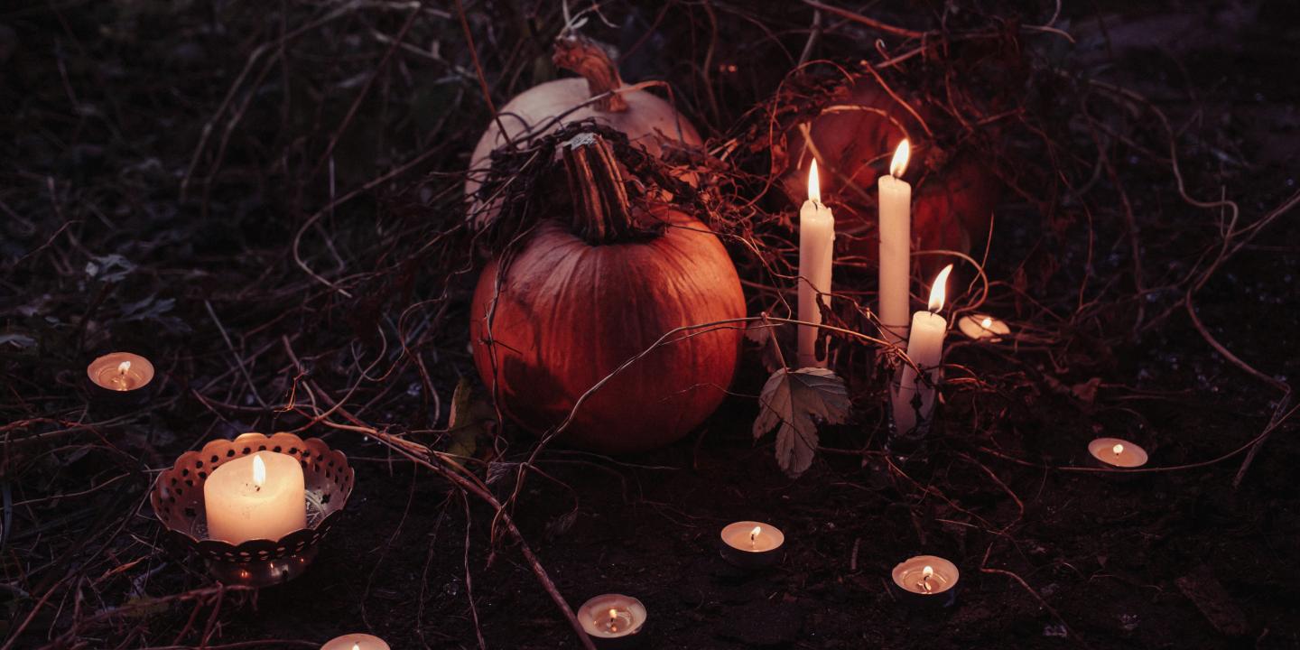 pumpkin between lighted candles