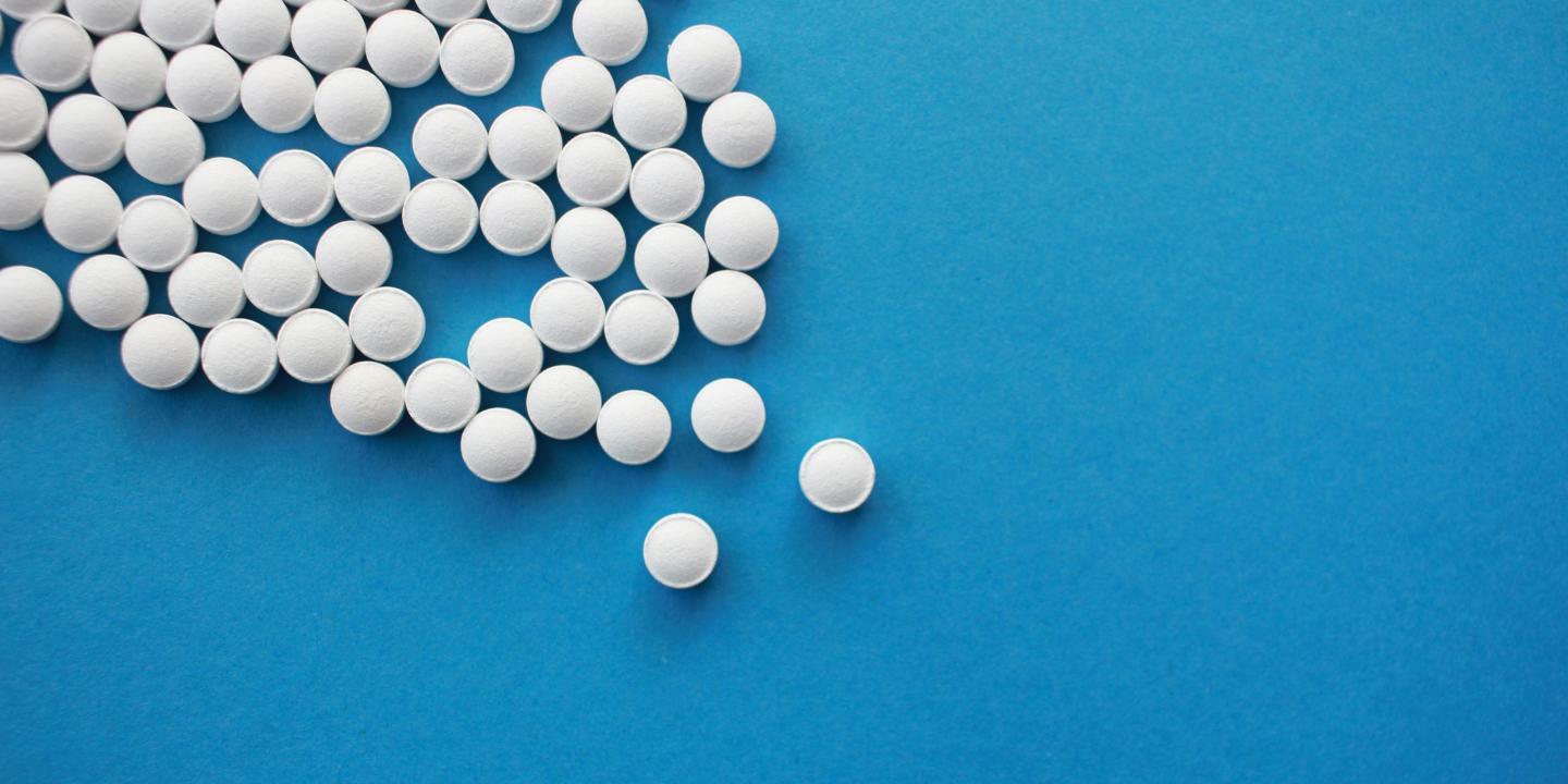 white pills form an angle on a blue background