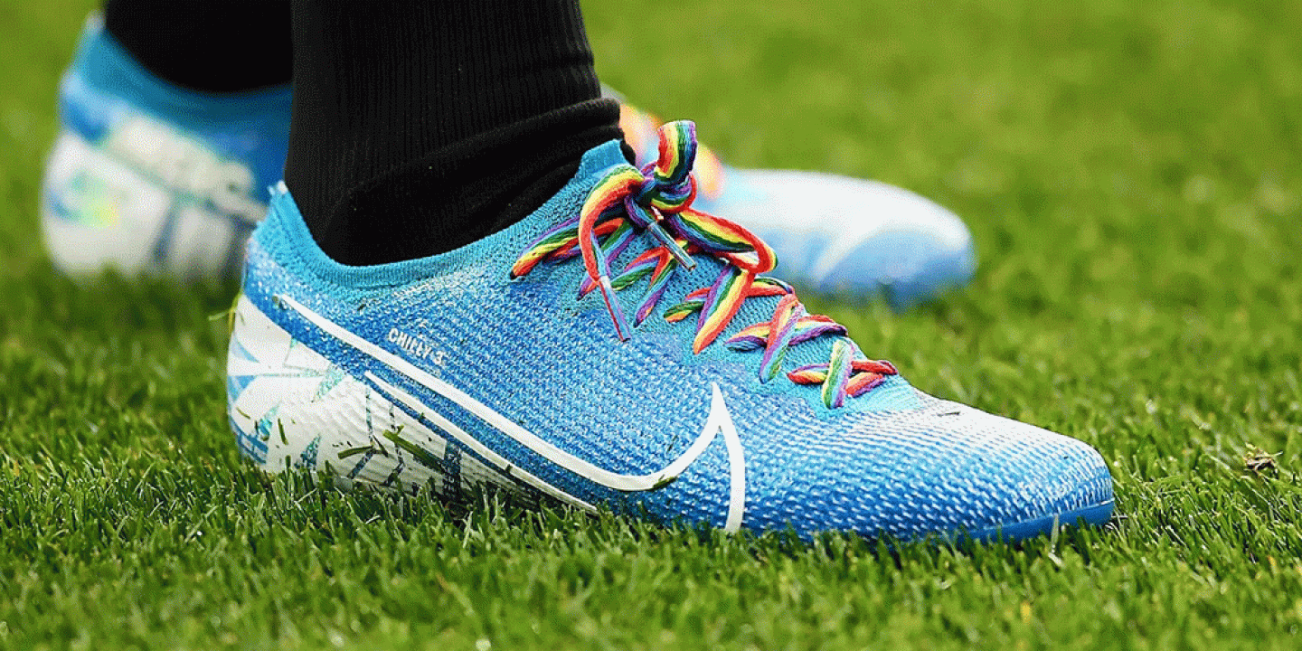 A football boot with rainbow laces