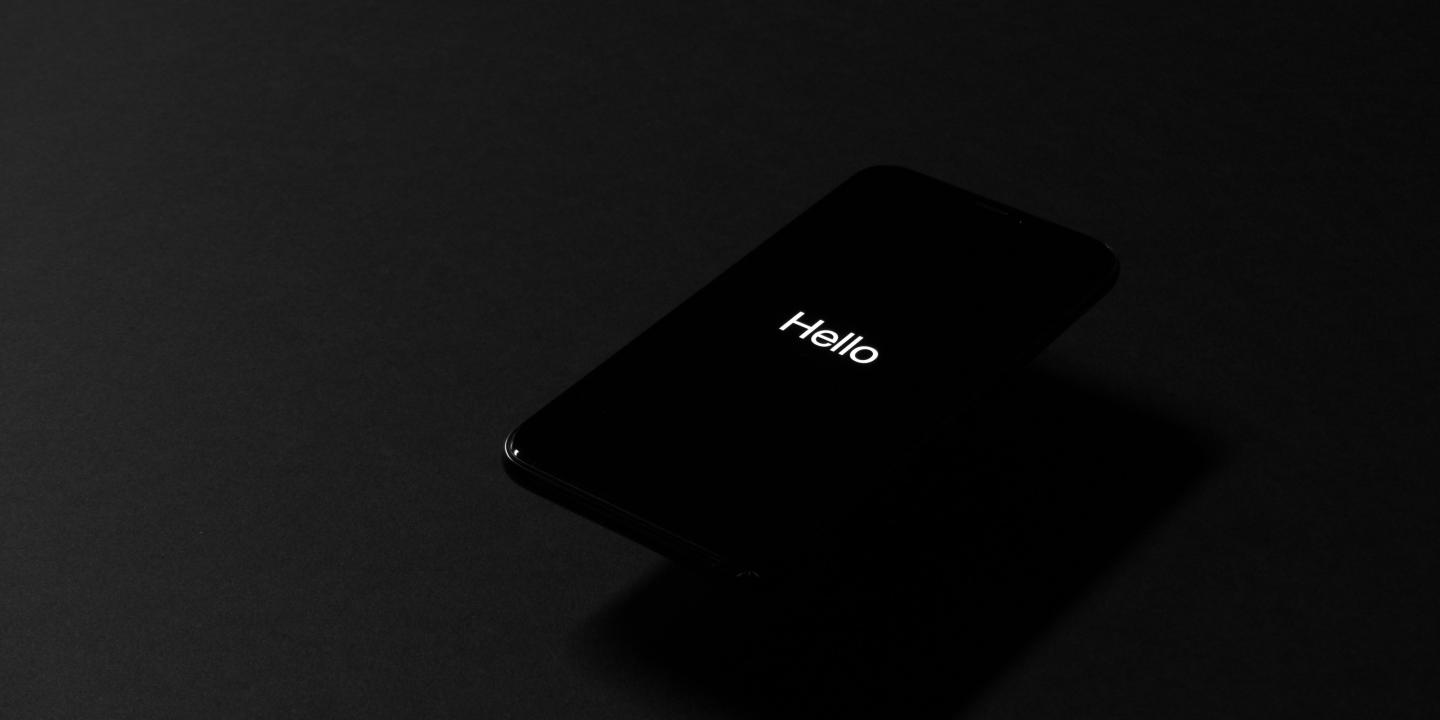 A dark image shows a dark screen with the tiny word 'hello' on it.