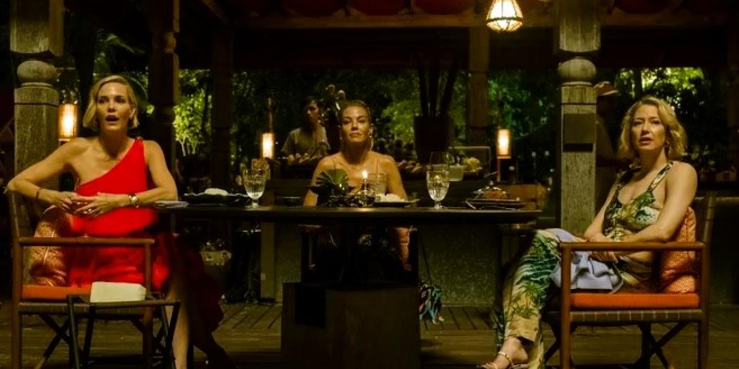 Three woman dining in a luxury hotel in Thailand, turn and look to the camera.