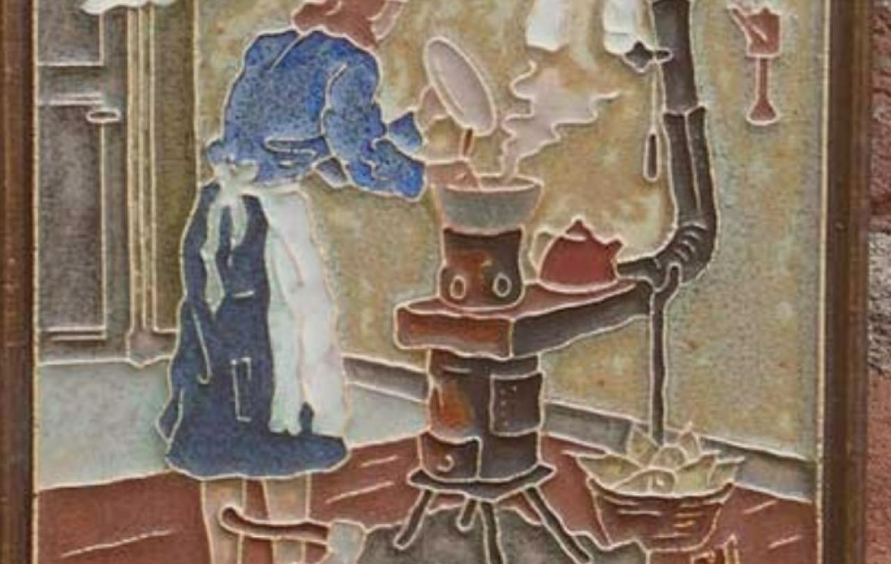 A wall tile shows a 1940s woman tend a stove below a washing line.