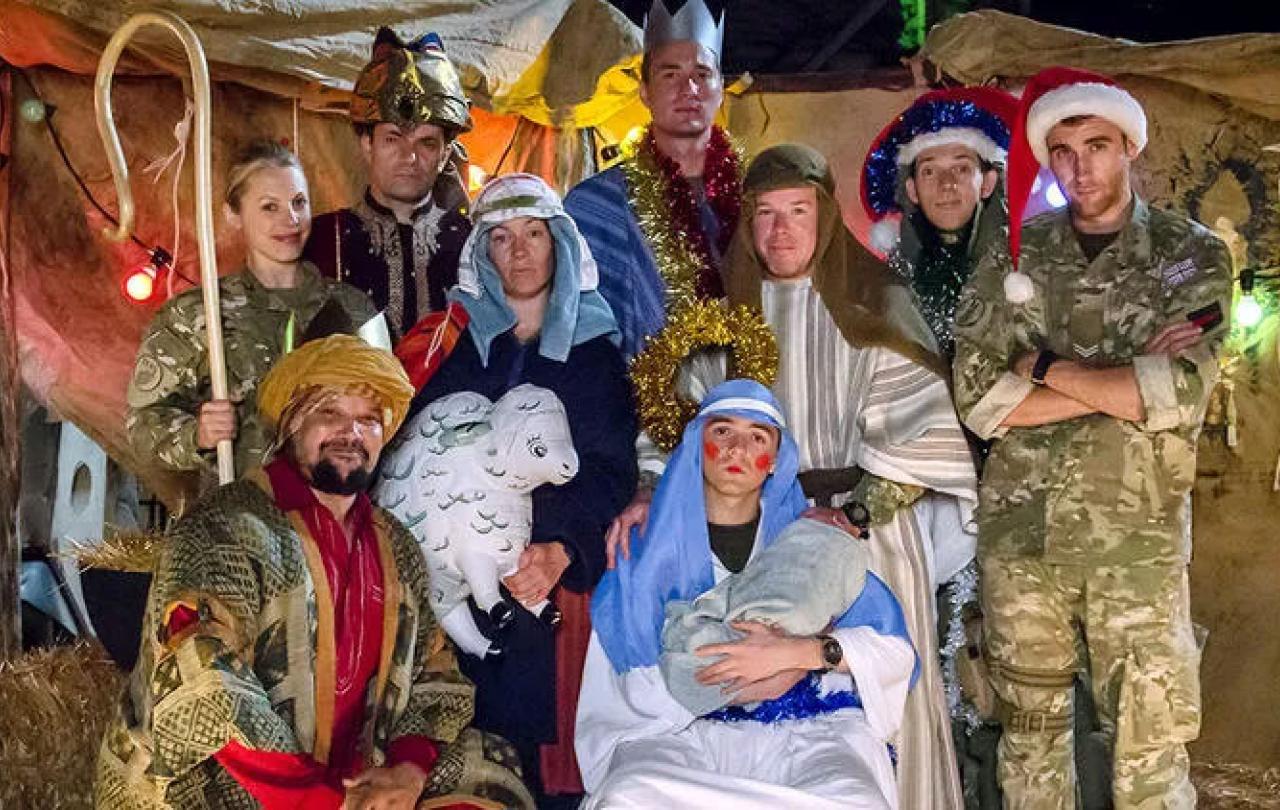 Dressed in camouflage uniforms and makeshift costumes, soldiers create a nativity scene