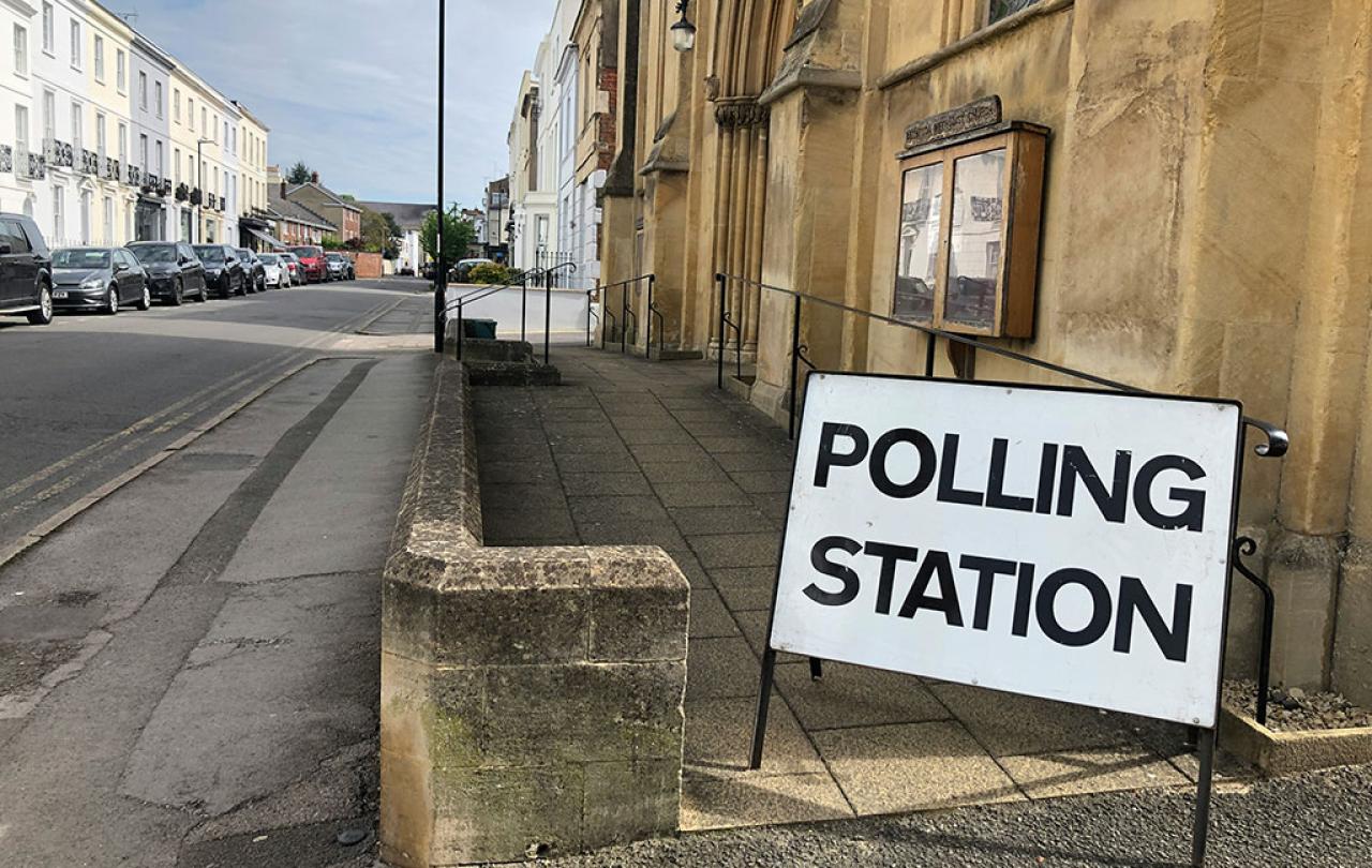 A sign reading 'polling station' stands by the entrance to a church.