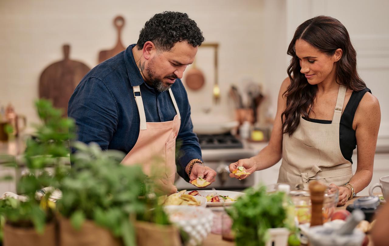 A man and a woman prepre food in a kitchen.