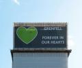 A wrapping around the Grenfell Tower bears a giant green heart.