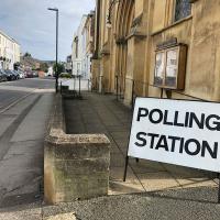 A sign reading 'polling station' stands by the entrance to a church.