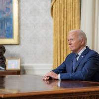 President Biden, at his desk after announcing his decision.