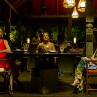 Three woman dining in a luxury hotel in Thailand, turn and look to the camera.